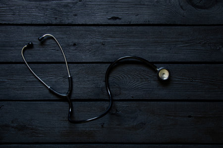 Stethoscope lies on a black wooden board close-up ,health and medicineの写真素材