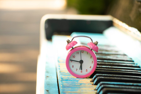Piano in blue paint on the street of the city of Dnipro in Ukraine against the background of an alarm clock, playing the piano and timeの写真素材