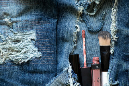 Hole makeup set in ripped jeans, makeup and style, glitter and mascara and brushの写真素材