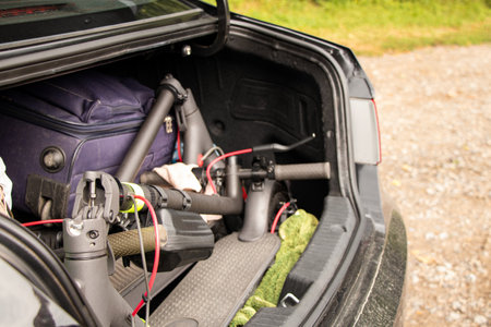 Two electric scooters and suitcases with things are in the trunk of a car that goes on vacation in Ukraine, vacation and travel by car with scootersの写真素材
