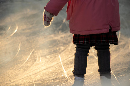 A little girl skates in a park in Ukraine in December, skatingの写真素材