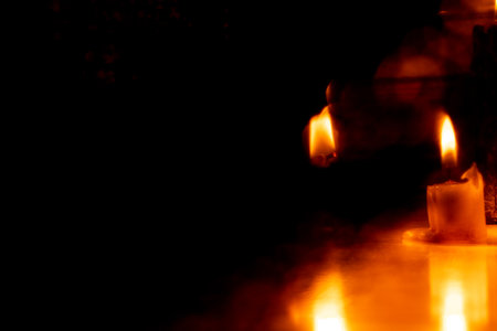 Candles in the dark on the floor in the shadows, candle flame, fireの写真素材