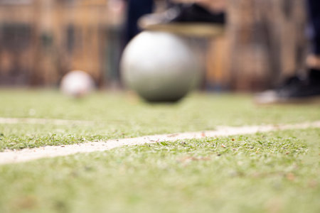 Female legs on a football field and a gray soccer ball in Ukraine,playing football in the yard