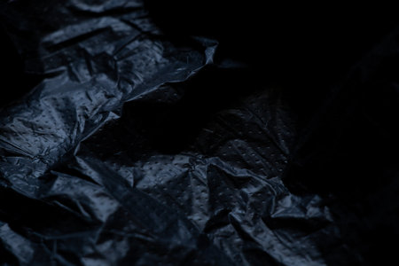 Black plastic bag as a background in the darkの写真素材