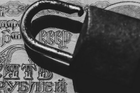 Ten rubles and the text USSR on which lies a rusty padlock, business and financeの写真素材
