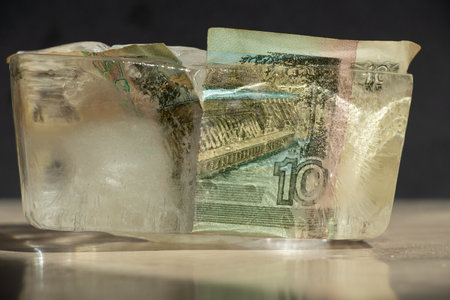 Ten Russian rubles in an ice cube close-up, frozen Russian money, sanctionsの写真素材