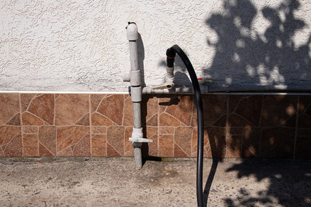 Plastic pipe and hose on a summer cottage in Ukraine, tap for watering the yard