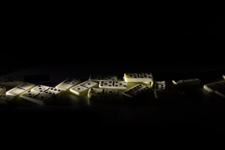 Dominoes in the dark in the rays of light , play dominoesの写真素材