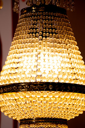 Old hanging chandelier turned on close up at homeの写真素材