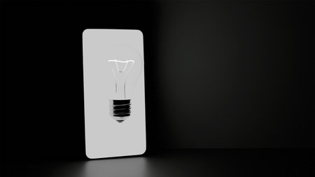 3D model of incandescent light bulb and mobile phone on black background close-upの写真素材