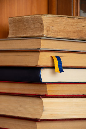 Collection of old books on a wooden shelf in a cabinet and a ribbon as a bookmark, books, educationの写真素材