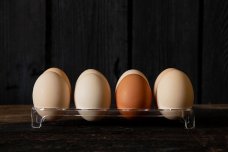 Chicken brown eggs on plastic stand on wooden background,eggs