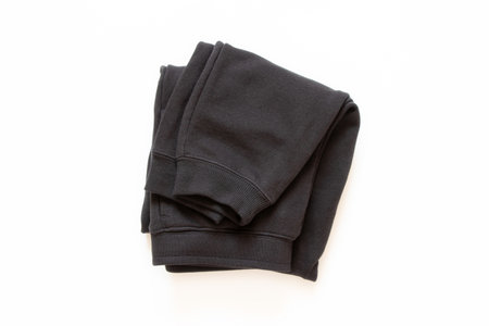 Black cotton sports pants close-up on white backgroundの写真素材