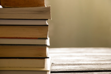 A stack of books lies on a wooden table at home, booksの写真素材