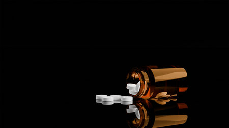 A jar of pills lies on a black mirror background, white tabletsの写真素材