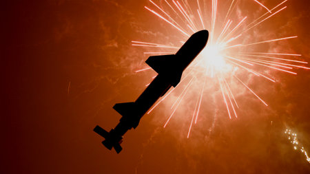 3D model of a ballistic missile against the backdrop of fireworks in the night sky, close-up of the missile prototypeの写真素材