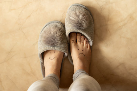 Drawing 2025 with sadness and on the second leg a smile is drawn on the legs of a girl in slippers...