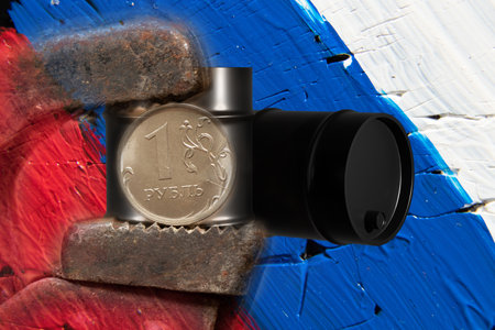 A gas wrench holds one ruble against the background of a black barrel of oil against the background of the Russian flag, sanctions and ban on oilの写真素材