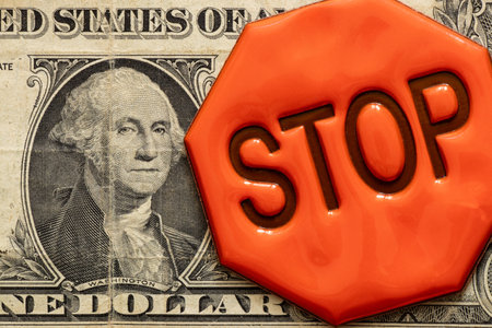 One dollar bill and a reflexive sign with the text stop close-up, stopの写真素材