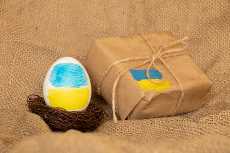 Easter egg with Ukrainian flag and a parcel with a flag, support for Ukraine during holidays,...