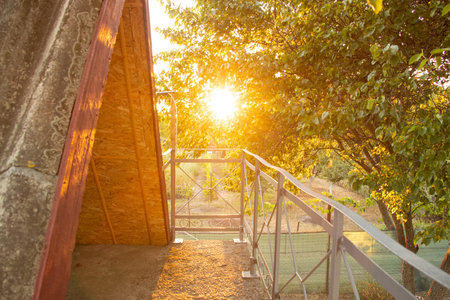 The comfort of the attic of a country house in the rays of the warm sunset in a village, country house, atticの写真素材