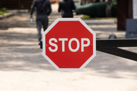 Red STOP sign on a barrier prohibiting entry into the territory in Ukraineの写真素材