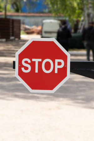 Red STOP sign on a barrier prohibiting entry into the territory in Ukraineの写真素材
