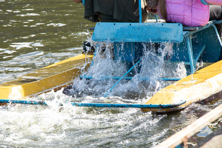 Catamaran with people floating near the pier on the Dnieper River in spring in Ukraine, old river catamaran on the riverの写真素材