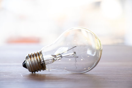 Broken spiral of a light bulb that lies on a table outside, a broken heating lampの写真素材