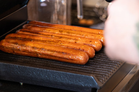 Grill sausages on the kitchen grill, fried sausage, street foodの写真素材