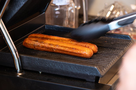 Grill sausages on the kitchen grill, fried sausage, street foodの写真素材