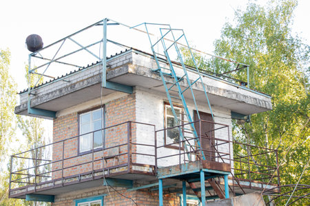 Observation two-story building brick building with stairs and balcony in Ukraine in the summer in the sunの写真素材