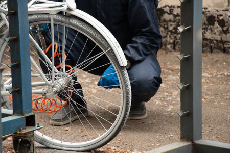 Painting an old bicycle with an airbrush outdoors in white, bicycle restoration, paintの写真素材