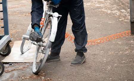 Painting an old bicycle with an airbrush outdoors in white, bicycle restoration, paintの写真素材