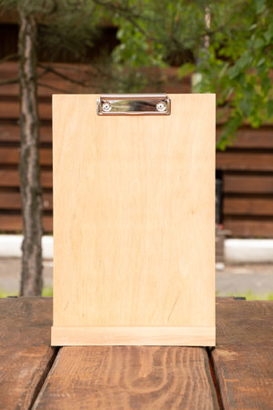 Empty wooden clipboard on table, empty space for advertisingの写真素材