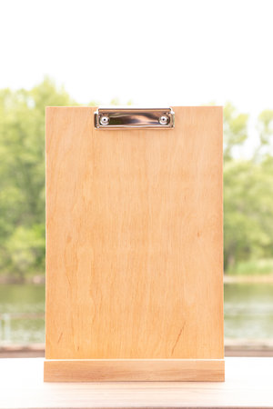 Empty wooden clipboard on table, empty space for advertisingの写真素材