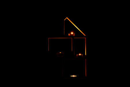 Decorative house with candles in the dark as decor in the apartmentの写真素材