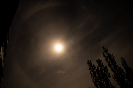 Halo around the moon at night in the sky, natural phenomenonの写真素材