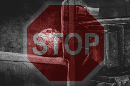 Globe and a box of weapons on the background of a stop signの写真素材
