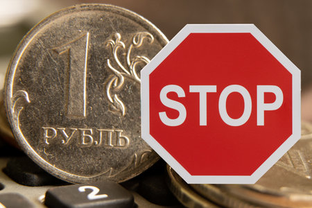 Sanctions against the ruble, one ruble and a red stop sign, sanctions