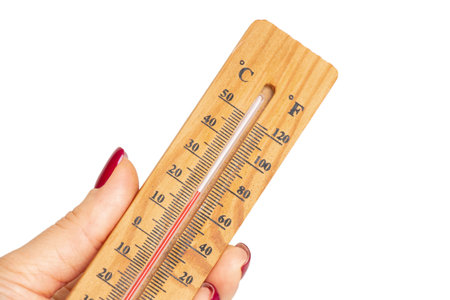 Wooden thermometer in woman's hand with high temperature on white background, hot summer and climate...