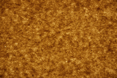 Brown textured paper in the light close-up, paper backgroundの写真素材