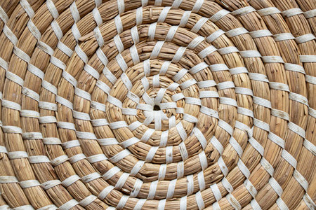 Straw round brown stand for dishes in the kitchen as a background, straw wicker backgroundの写真素材