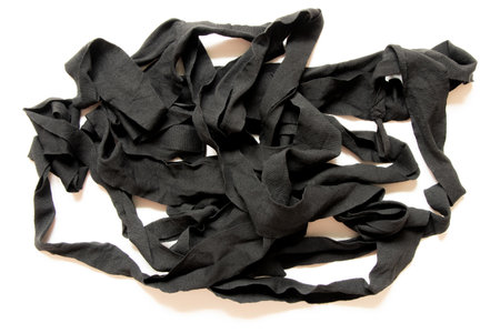 Black textile tapes and ropes on a white background, bandages for hand protectionの写真素材