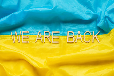 Flag of Ukraine with the inscription We are back, symbol of the return of captured heroes home to Ukraine from Russian prisonsの写真素材