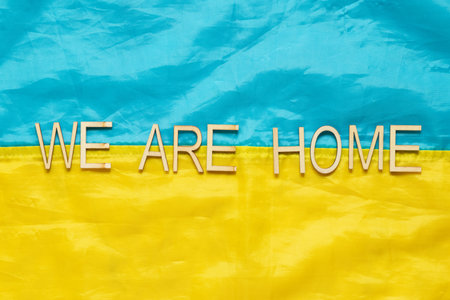 Flag of Ukraine with the inscription We are home, symbol of the return of captured heroes home to Ukraine from Russian prisonsの写真素材