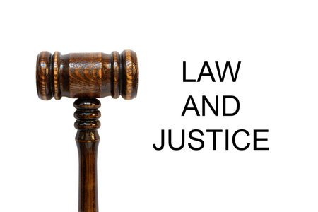 Judge's gavel lies on a white background and the inscription Law and Justice, judicial themeの写真素材