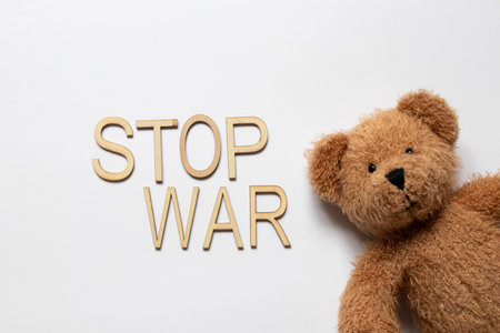 Teddy bear and the phrase stop war on a white background, war, suffering of children and civiliansの写真素材