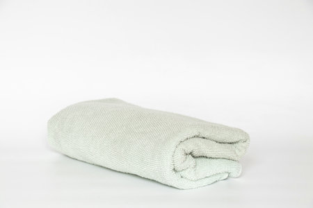 Light blue towel, folded on white background, hygiene and home textile itemの写真素材