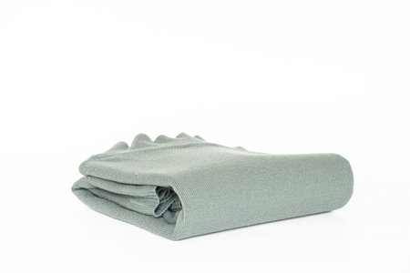 Folded pale green men's turtleneck sweater on a white background, clothing for a catalog or online storeの写真素材